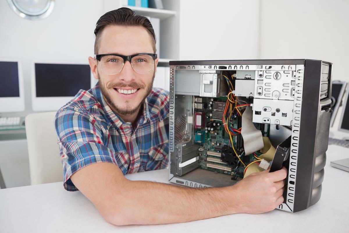 Smiling man with computer hardware