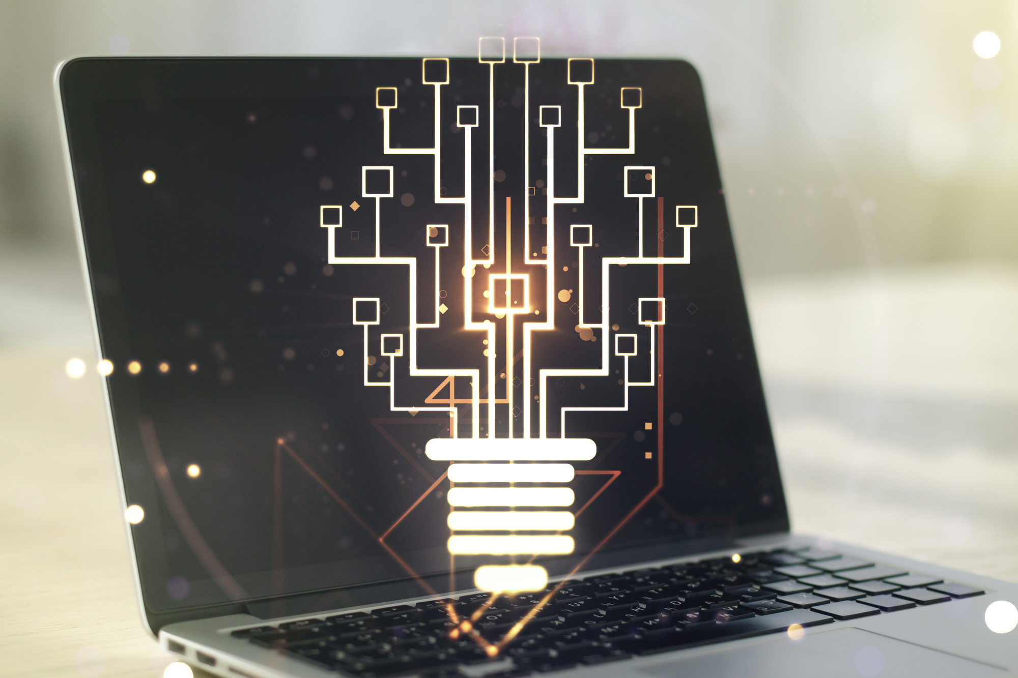 Light builb with chip hologram against background of a modern laptop