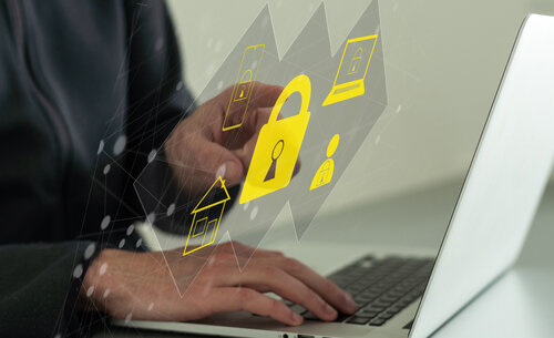Businessman using laptop with padlock security authentication interface for secure login