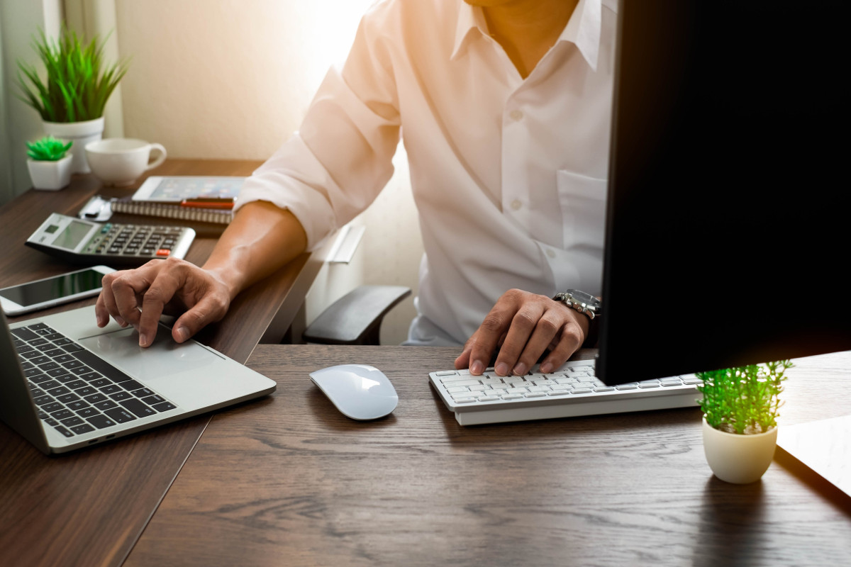 Man using computer and laptop in and office