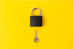 Lock and key on yellow background