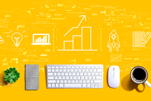 Business growth analysis with a keyboard and mouse in white and yellow